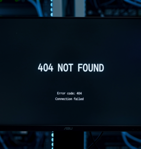 Monitor in server room displaying 404 Not Found error with blue LED server rack lighting