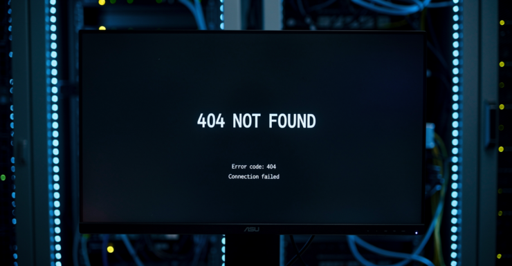 Monitor in server room displaying 404 Not Found error with blue LED server rack lighting
