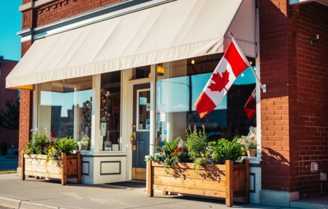 Canadian small business storefront on a main street with a Canadian flag