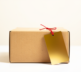 Plain cardboard box with an oversized blank gold price tag attached by a red string