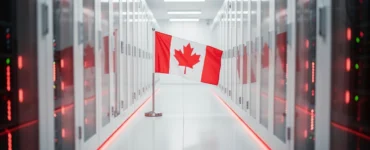 A small Canadian flag standing in a bright modern data centre aisle with red LED accents