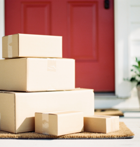 Unopened delivery parcels stacked on a front doorstep