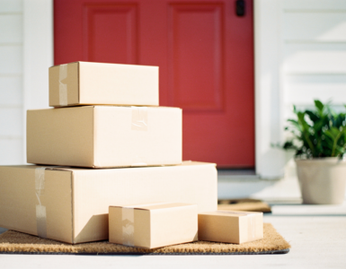 Unopened delivery parcels stacked on a front doorstep